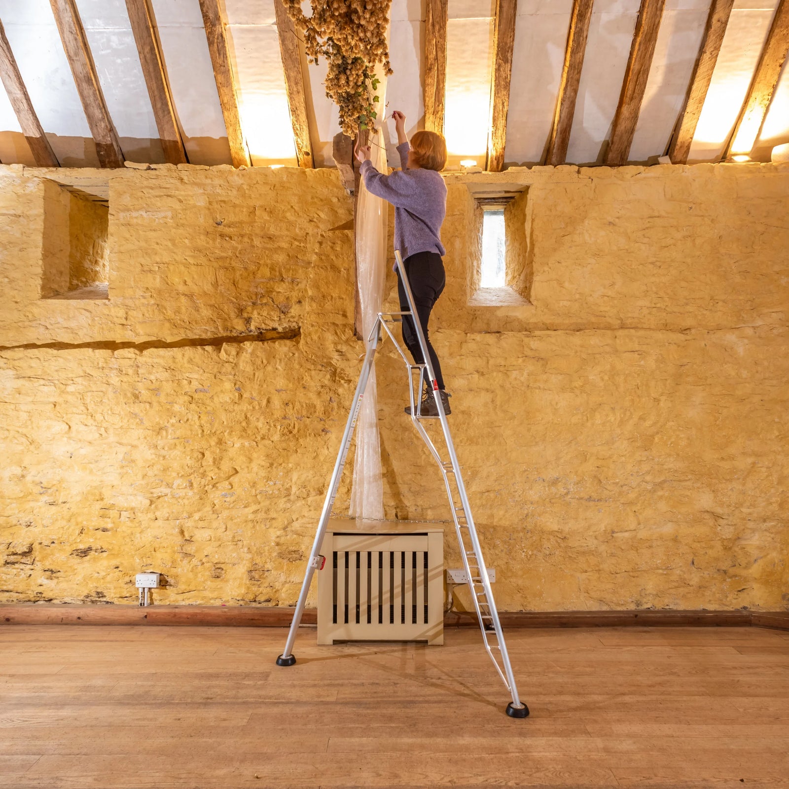 Rear Adjustable Leg Tripod Ladder - being used indoors