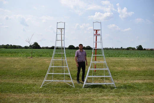Man standing next to two Henchman Tripod Ladders